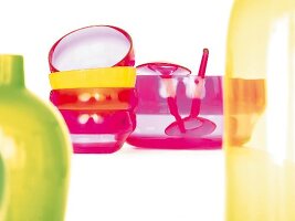 Multi-coloured glass bowls stacked against white background