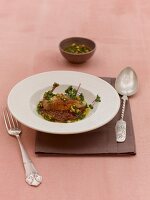 Quail and chocolate potato stew with gremolata on plate