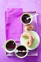 Churros on plate served with hot chocolate in bowls, Spain