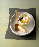 Bowl of rice pudding and apple slice on serving dish