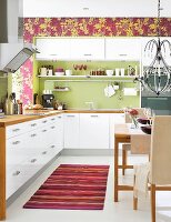 White kitchen-dining room with green and purple accents