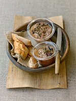 Wild boar pate with bread in wooden bowl