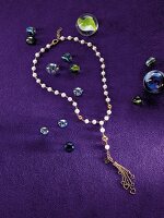 Gold and pearl chain on purple background