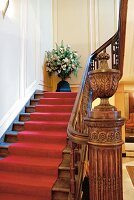 Staircase with red carpet and wooden railings at Hotel Dixseptieme in Brussels, Belgium
