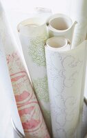 Various floral patterned murals rolled in basket