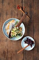 Bulgur salad with chicken in bowl, overhead view