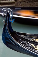 Close-up of tip of Gondola with ornate decoration at Venice, Italy