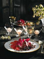 Rabbit liver with pancetta on chicory, lit candles and wine in background