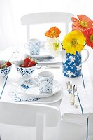 Table laid with porcelain crockery and vase