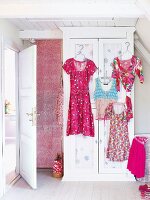 Close-up of summer clothes hanging on wardrobe
