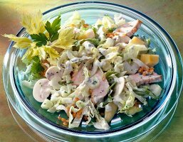 Iceberg salad with celery and turkey on glass plate