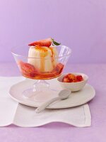 Curd parfait with marinated strawberries in glass ice cream bowl