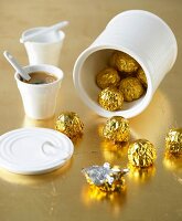 Chocolates in white ceramic can and espresso cup