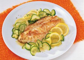 Redfish fillet with lemon zucchini on plate