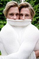 Portrait of two blonde men wearing white sweater