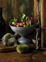 Silver fruit bowl of salad with glazed chestnuts, mushrooms and fruits