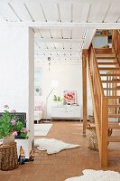 Wooden staircase leading from ground floor to sleeping area; white metal cabinet in background