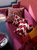 Differently patterned pillows on sofa