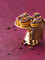 Chocolate marzipan biscuits with almonds on cake stand