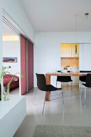 Dining room with wooden table, chairs and pink sliding door