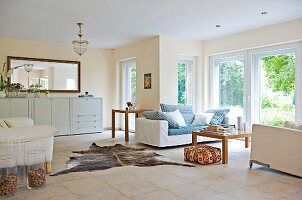 Bright living room with sitting area, window and animal fur on floor