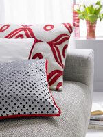 Gray and red cushions on gray sofa