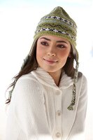 Beautiful woman wearing white cardigan and green knit cap, smiling
