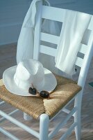 Straw hat with scarf on bed