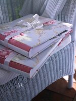 Photo albums with fabric rose lying on chair