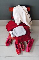 Cashmere sweaters in red and white on chair