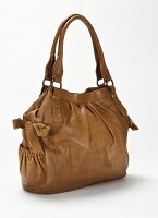 Close-up of brown leather handbag with loops side