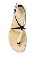 Close-up of sandal with beaded straps on white background