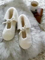 White woollen slippers on fur carpet
