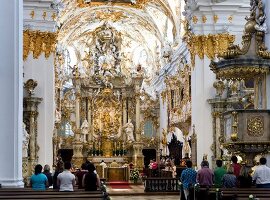 People in Rococo style chapel in Regensburg, Bavaria, Germany