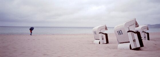Three white hooded beach chairs on beach, Stralsund, Mecklenburg-Vorpommern, Germany