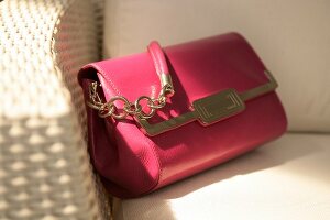 Close-up of pink handbag with chain handle