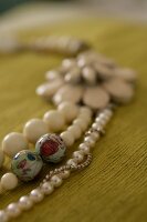 Close-up of pearl necklace on wooden background