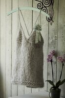 Knitted top with spaghetti straps and a flower bow on hanger