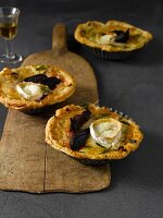 Goat cheese tarts on wooden serving plate