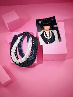 Various necklaces with photo on pink background