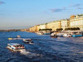 View of boats in Neva River and Hermitage Museum in St. Petersburg, Russia