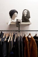 Warm clothes hanging on hanger in shop