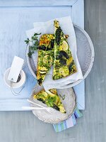 Green vegetable frittata with peas, spinach and zucchini on dish