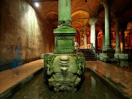 Enormous Basilica Cistern Medusa head pillar in water, Istanbul, Turkey