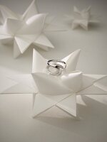 White gold and diamond ring on white decoration