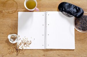 Notepad with blank pages, nutmeg and lavender seeds