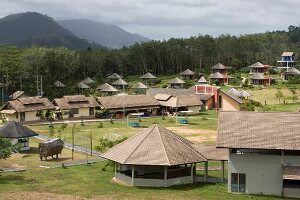 View of small huts and sports ground at Beluga School for Life, Thailand