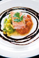 Close-up of sesame salmon with tomato sauce and mango salad on plate