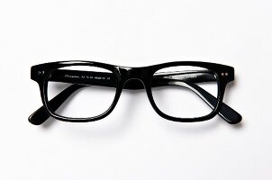 Close-up of black glasses on white background