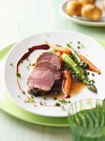 Veal fillet with a herb crust, green asparagus and carrots